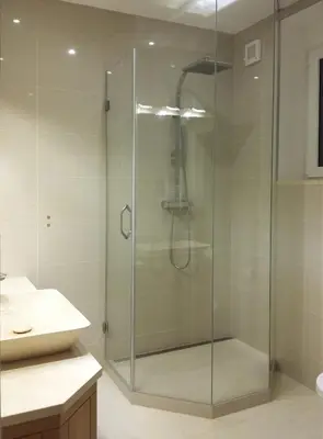 a glass shower in a bathroom with a sink at New apartment in a historical building in Prague