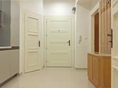 a kitchen with white doors and a white floor at New apartment in a historical building in Prague