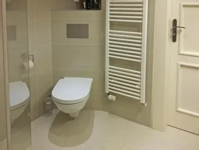 a bathroom with a white toilet and a sink at New apartment in a historical building in Prague
