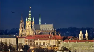a large building with a clock tower and a castle at Apartment Sedlčanská - You Will Save Money Here - equipped with antique furniture in Prague