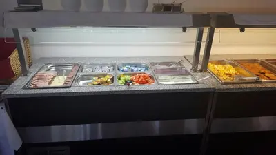 a refrigerator filled with lots of different types of food at Hotel ELMA in Srbsko