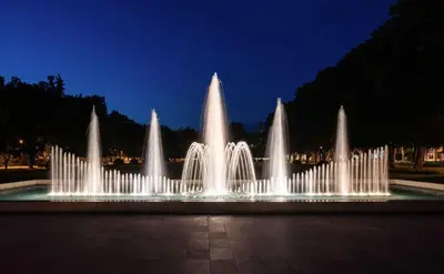 a water fountain in a park at night at Apartment Spa and Fontain Poděbrady in Poděbrady