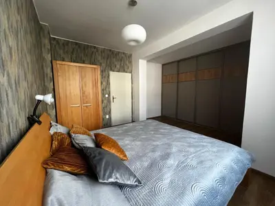 a bedroom with a bed with pillows on it at Apartment Spa and Fontain Poděbrady in Poděbrady