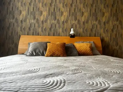 a bedroom with a bed with a wooden headboard at Apartment Spa and Fontain Poděbrady in Poděbrady