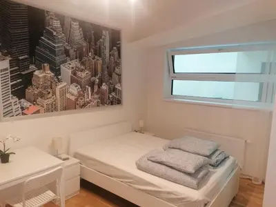 a small bedroom with a bed and a window at Studio brand new apartment #28 in new building with free parking in city center in Prague