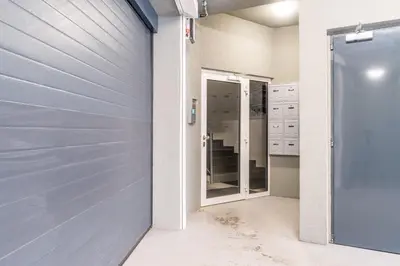 a garage door in a bathroom with a mirror at Studio brand new apartment #28 in new building with free parking in city center in Prague