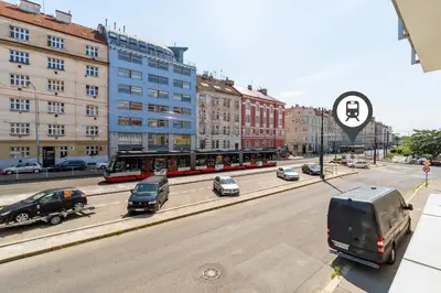 a street with cars and a bus on a city street at Studio brand new apartment #28 in new building with free parking in city center in Prague