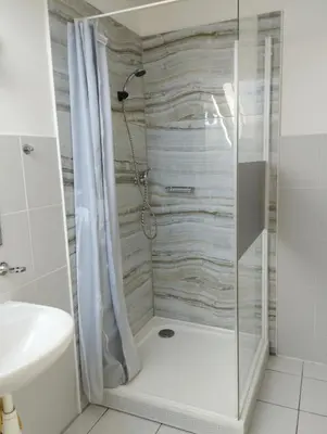 a bathroom with a shower and a toilet and a sink at Apartmány Audy in Mníšek pod Brdy