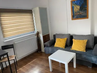 a living room with a couch and a table at Apartmán - F - Vyhlídka nad řekou in Zdiby