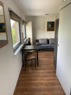 a living room with a table and a couch at Apartmán - F - Vyhlídka nad řekou in Zdiby