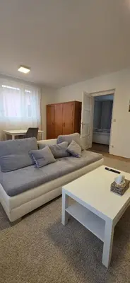 a bedroom with a large bed and a white table at Apartmán Na Polabí 2 in Mělník