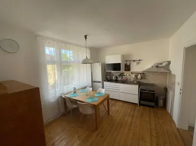 a kitchen with a table and chairs in a room at Apartmán Na Polabí 2 in Mělník