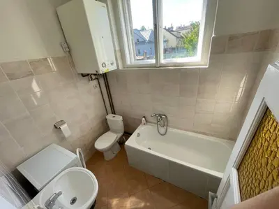 a bathroom with a toilet and a tub and a sink at Apartmán Na Polabí 2 in Mělník