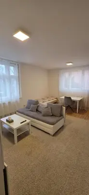 a living room with a bed and a table at Apartmán Na Polabí 2 in Mělník