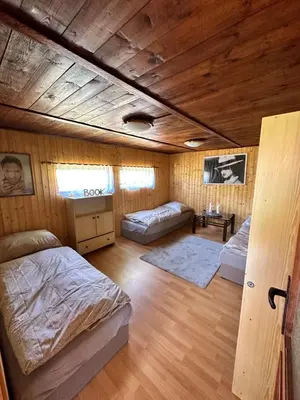 a bedroom with two beds and a couch in it at Chata U Řeky in Volenice