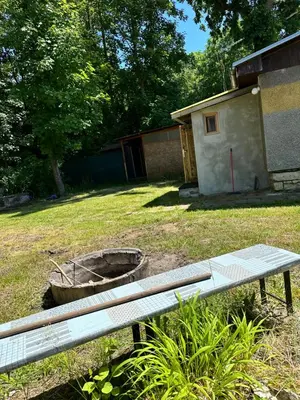 a bench sitting in a yard next to a building at Chata U Řeky in Volenice