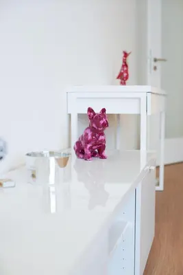 a purple teddy bear sitting on top of a white cabinet at Holešovice Delight: Modern Comfort with a Twist in Prague 7 in Prague