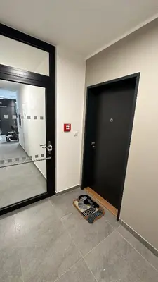 a room with a door and a mat on the floor at Holešovice Delight: Modern Comfort with a Twist in Prague 7 in Prague