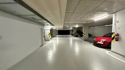 a parking garage with two cars parked in it at Holešovice Delight: Modern Comfort with a Twist in Prague 7 in Prague