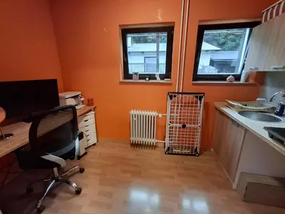 a kitchen with a desk and a chair in a room at Pokoj v rodinném se sdílenou koupelnou in Černošice