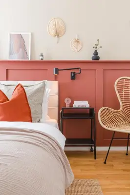 a bedroom with a red wall with a bed and a chair at TurnKey I National Museum Apartments in Prague