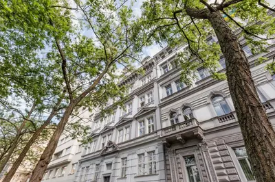 a large white building with trees in front of it at TurnKey I National Museum Apartments in Prague