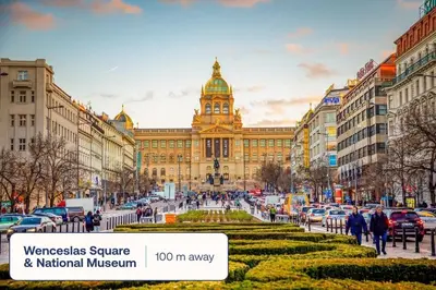 a large building with a clock tower in a city at TurnKey I National Museum Apartments in Prague