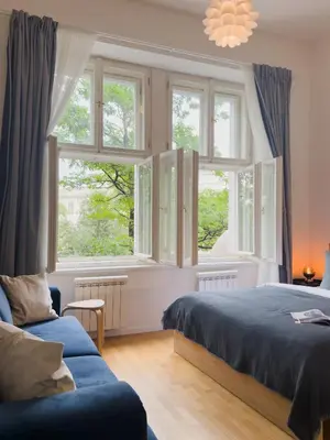 a bedroom with two beds and two windows at TurnKey I National Museum Apartments in Prague