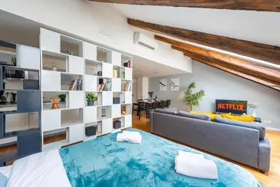 a living room with a large bed and a couch at Duplex apartment with AC in Prague Center in Prague