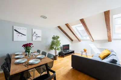 a living room with a table and a couch at Duplex apartment with AC in Prague Center in Prague