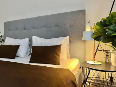 a bedroom with a large bed with a large headboard at Beautiful New Town Apartment in Prague