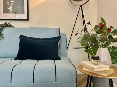 a living room with a green chair in a kitchen at Beautiful New Town Apartment in Prague
