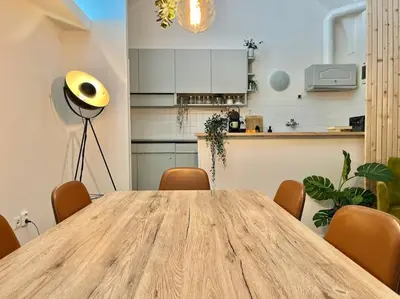 a wooden table in a room with a kitchen at Beautiful New Town Apartment in Prague
