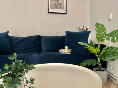 a bedroom with a bed and a table and a bed with plants at Beautiful New Town Apartment in Prague
