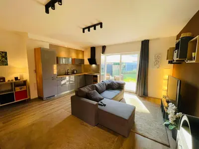 a living room with a couch and a kitchen at Letní dům Ždáň in Slapy
