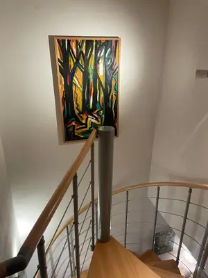 a painting hanging on a wall next to a staircase at Letní dům Ždáň in Slapy