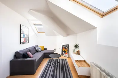 a living room with a couch and a table at Bohéme Apartment Prague Three in Prague