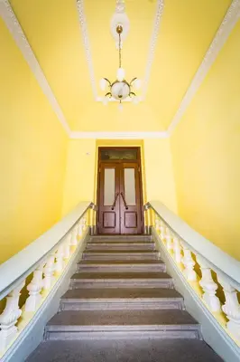 a staircase in a house with a chandelier at Bohéme Apartment Prague Three in Prague