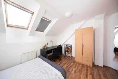a bedroom with a bed and a desk at Bohéme Apartment Prague Three in Prague