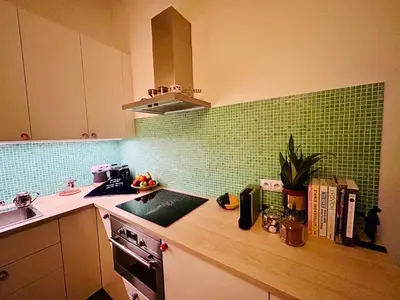 a kitchen with green tile on the wall at Green balcony & king size bed in Prague