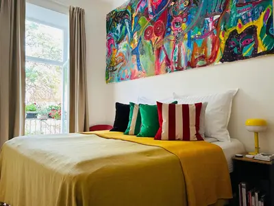 a bedroom with a bed with a painting on the wall at Green balcony & king size bed in Prague