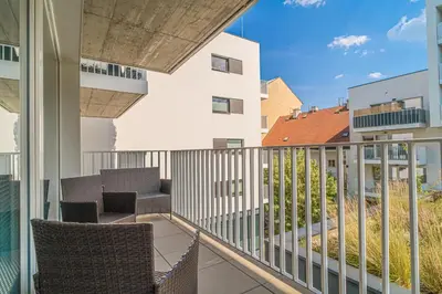 a balcony with chairs and tables on a building at Apartment Karel with garage parking in Prague