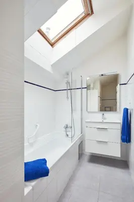 a white bathroom with a tub and a sink at Karlova Old Town Apartments in Prague