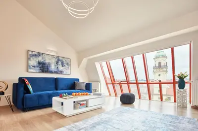 a living room with a blue couch and a table at Karlova Old Town Apartments in Prague