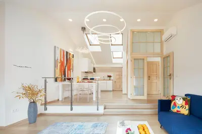 a living room with a blue couch and a kitchen at Karlova Old Town Apartments in Prague
