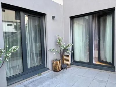 a pair of windows on a building with trees at Apartment Dagmar Burešové in Prague