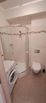 a white bathroom with a toilet and a shower at Apartment 153 - Rezidence Eliska - Prague 9 in Prague