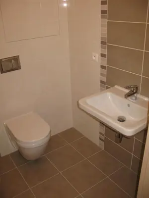 a bathroom with a toilet and a sink at Apartment 153 - Rezidence Eliska - Prague 9 in Prague