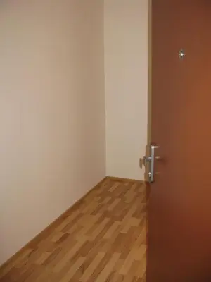 an empty room with a door and a wooden floor at Apartment 153 - Rezidence Eliska - Prague 9 in Prague