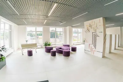 a large room with a piano and purple stools at Apartment 153 - Rezidence Eliska - Prague 9 in Prague